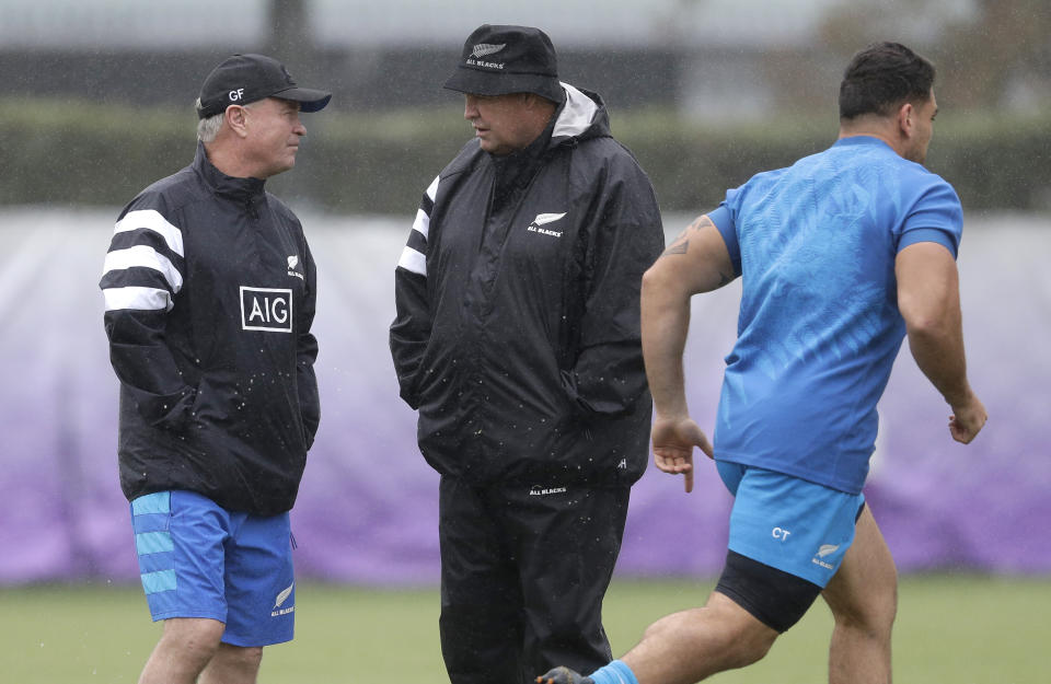 New Zealand coach Steve Hansen talks with selector Grant Fox, left, during a training session in Tokyo, Japan, Tuesday, Oct. 22, 2019. The All Blacks play England in a Rugby World Cup semifinal in Yokohama on Saturday Oct. 26. (AP Photo/Mark Baker)