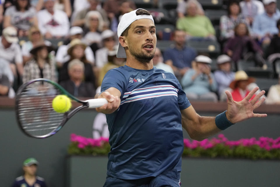 Pedro Cachin, of Argentina, returns a shot to Alexander Zverev, of Germany, at the BNP Paribas Open tennis tournament Friday, March 10, 2023, in Indian Wells, Calif. (AP Photo/Mark J. Terrill)