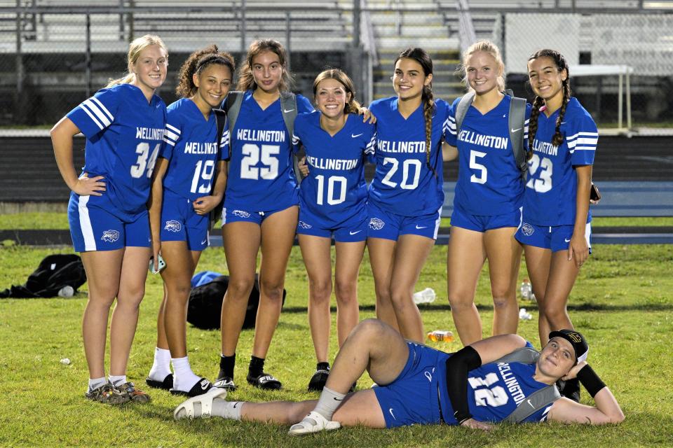 Members of the Wellington Wolverines pose for a celebratory photo following the squad's 25-13 district semifinals win over Forest Hill Wednesday night. The victory clinched an appearance in the district championship, where the team will face Seminole Ridge Thursday night.