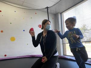 A child and a behavior therapist play at an InBloom Autism Services Learning Center.