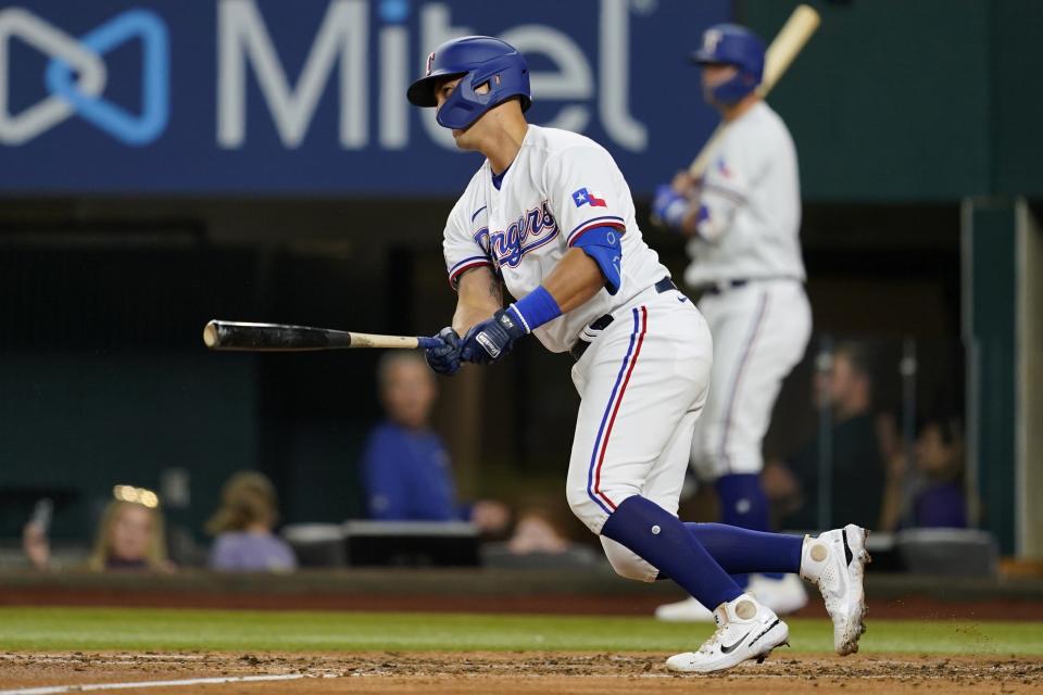 Texas Rangers' Mark Mathias follows through on an RBI single during the third inning of the team's baseball game against the Oakland Athletics in Arlington, Texas, Wednesday, Sept. 14, 2022. (AP Photo/Tony Gutierrez)