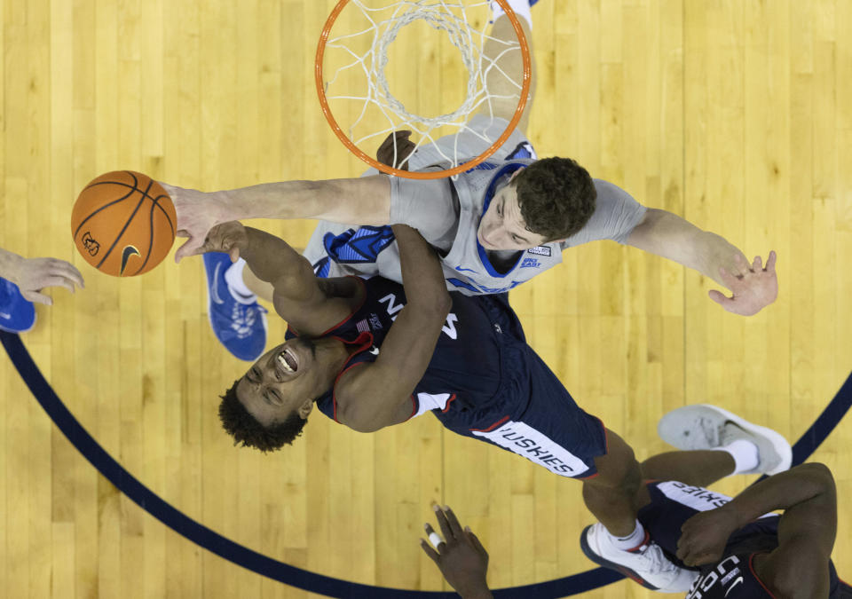 UConn's Nahiem Alleyne, left, shoots against Creighton's Ryan Kalkbrenner during the first half of an NCAA college basketball game on Saturday, Feb. 11, 2023, in Omaha, Neb. (AP Photo/Rebecca S. Gratz)