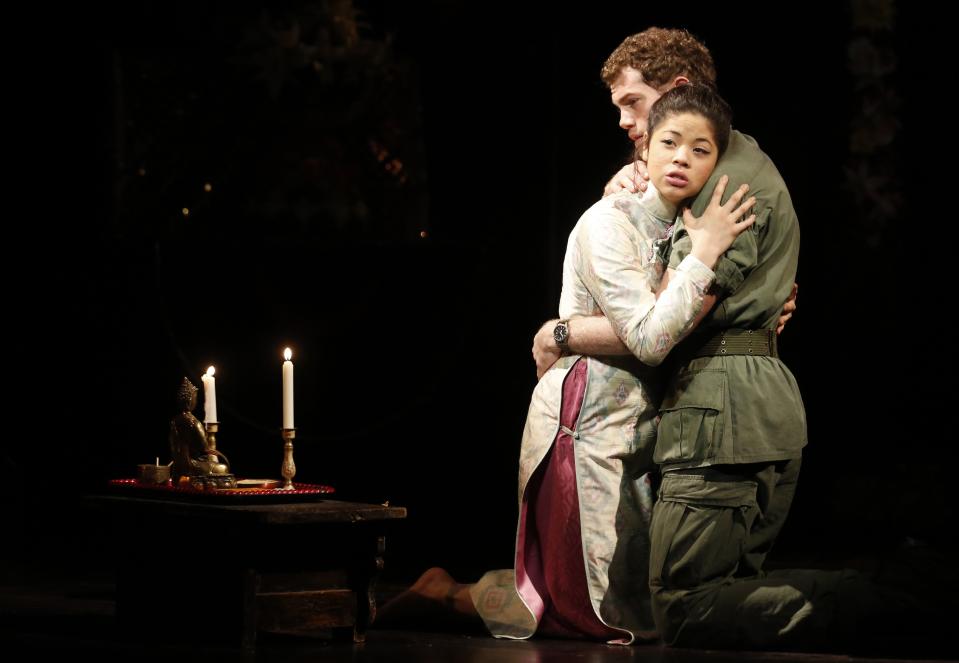 Actors Alistair Brammer and Eva Noblezada perform as Chris and Kim during a photocall for a new production of "Miss Saigon" at the Prince Edward Theatre in London May 19, 2014. The production marks the 25th anniversary of the musical by Claude-Michel Schonberg and Alain Boubil. REUTERS/Luke MacGregor (BRITAIN - Tags: ENTERTAINMENT)