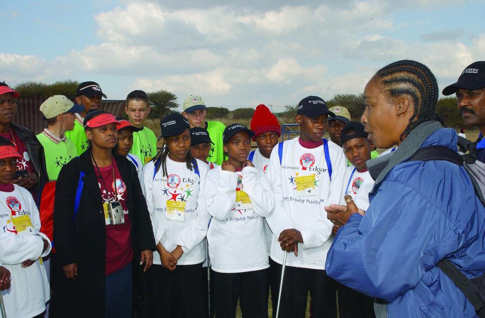 Claiborne (far right) speaks with student athletes in South Africa.