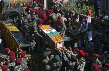 Indian Army soldiers remove a coffin containing the body Tushar Mahajan, an army officer who was killed in a gunbattle, from a vehicle after his wreath laying ceremony in Udhampur, north of Jammu, REUTERS/Mukesh Gupta