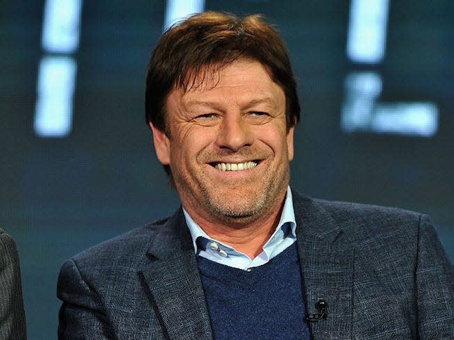 sean bean wearing a blue sweater and gray blazer