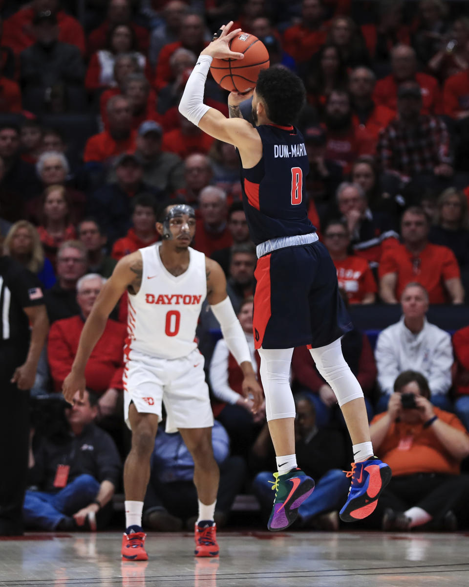 Duquesne's Tavian Dunn-Martin (0) makes a 3-point basket in the first half of an NCAA college basketball game against Dayton, Saturday, Feb. 22, 2020, in Dayton, Ohio. (AP Photo/Aaron Doster)