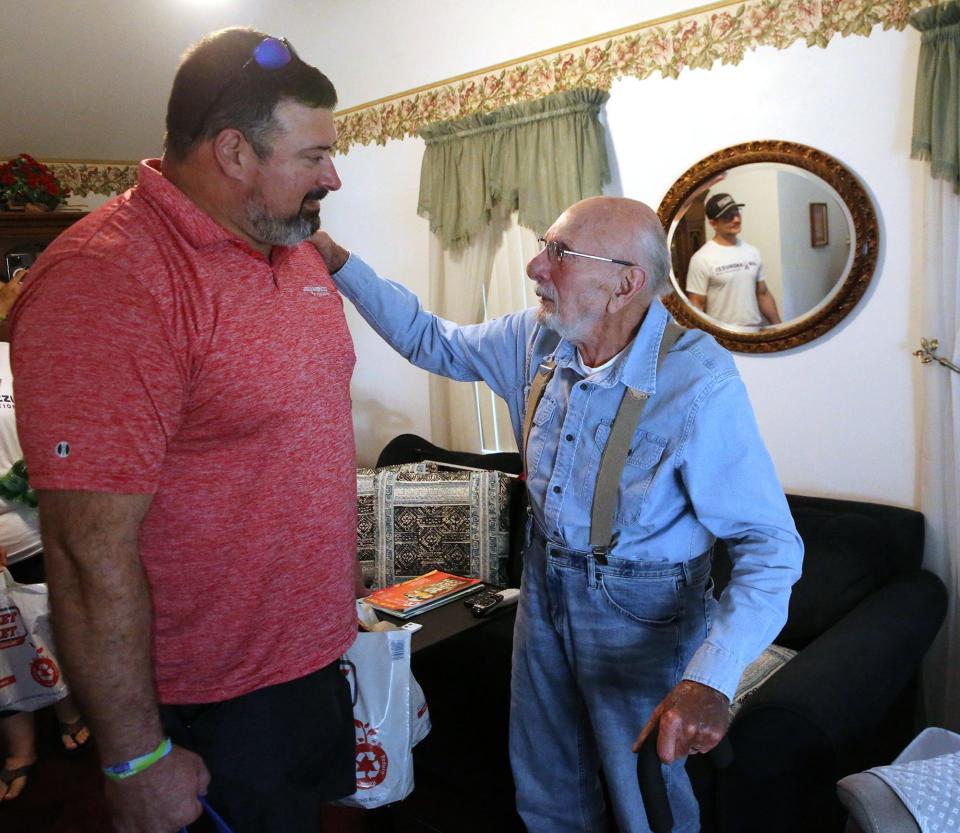 Stratham's Rudy Longo is overwhelmed by a grocery delivery by three-time Super Bowl champion Joe Andruzzi, a former offensive lineman for the New England Patriots Wednesday, July 13, 2023. Joe's son, Hunter, is reflected in the mirror.