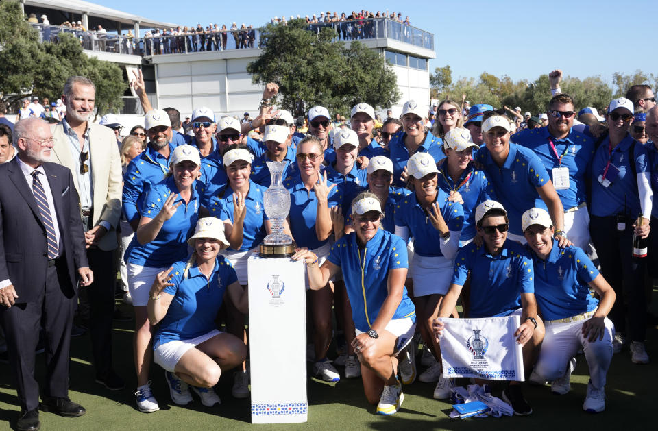 Spanish King Felipe VI stands next to Europe's golf team members as they pose with the trophy after wining the Solheim Cup golf tournament in Finca Cortesin, near Casares, southern Spain, Sunday, Sept. 24, 2023. Europe has beaten the United States during this biannual women's golf tournament, which played alternately in Europe and the United States. (AP Photo/Bernat Armangue)