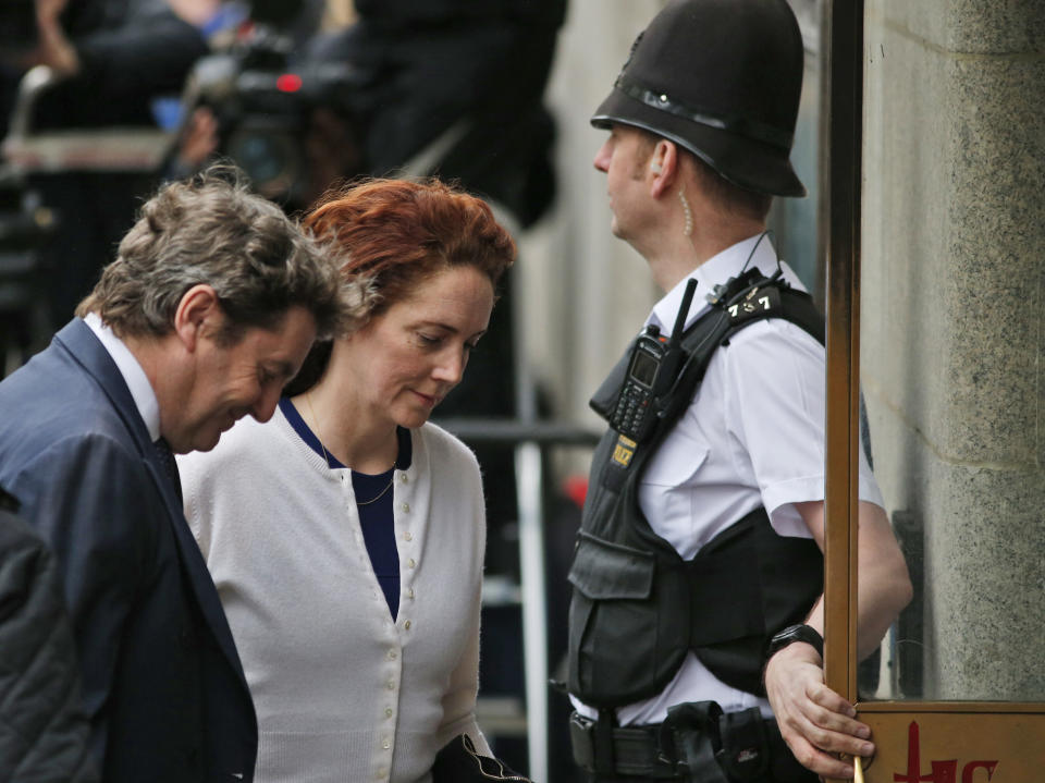 Rebekah Brooks, centre, former News International chief executive, and her husband Charlie Brooks, left, arrive at the Central Criminal Court in London where she appears to face charges related to phone hacking, Thursday, Feb. 20, 2014. (AP Photo/Lefteris Pitarakis)