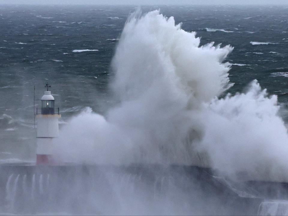 Large waves crash over the harbour wall as Storm Nelson hits Newhaven, Sussex (Reuters)