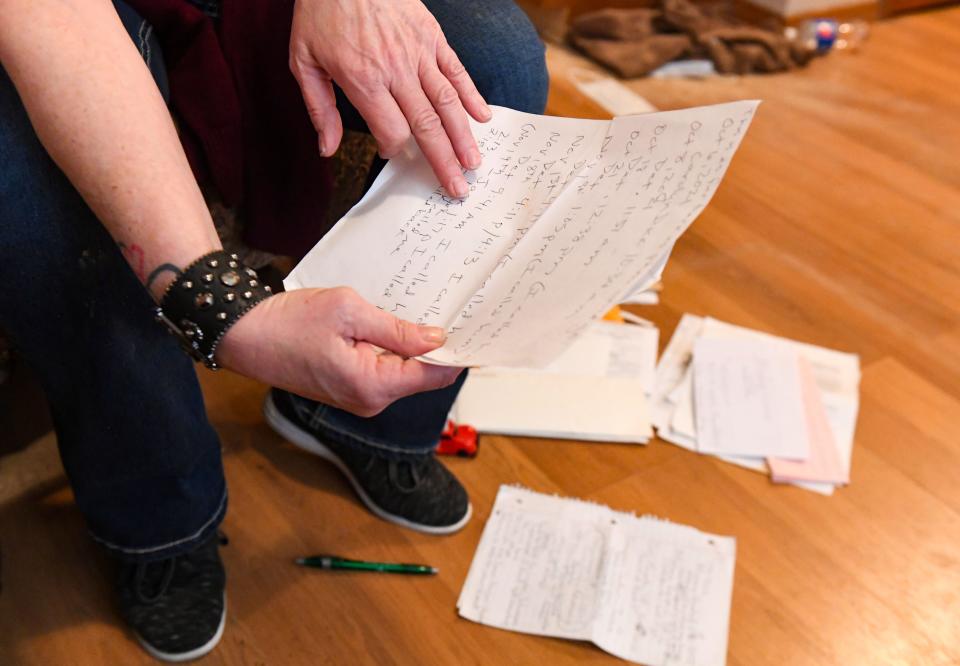 Penny talks looks through a pile of documents she has kept regarding her sexual assault case on Thursday, April 14, 2022, at her home in Sioux Falls. The documents include notes on phone calls she's had with law enforcement on her case and people advocating on her behalf.