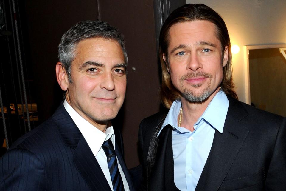 Actors Brad Pitt (L) and George Clooney