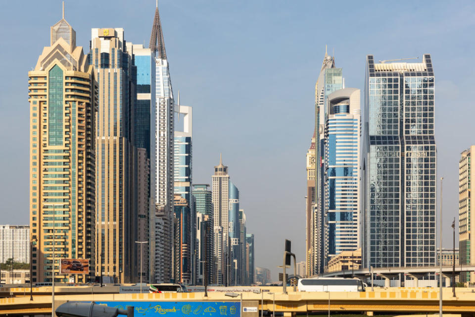 A cityscape view of Dubai's modern skyline featuring numerous high-rise buildings with varied architectural designs