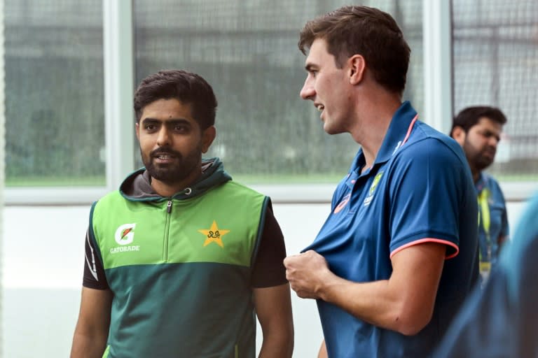 Australia captain Pat Cummins (R) chats with Pakistan batsman Babar Azam at the Melbourne Cricket Ground (William WEST)