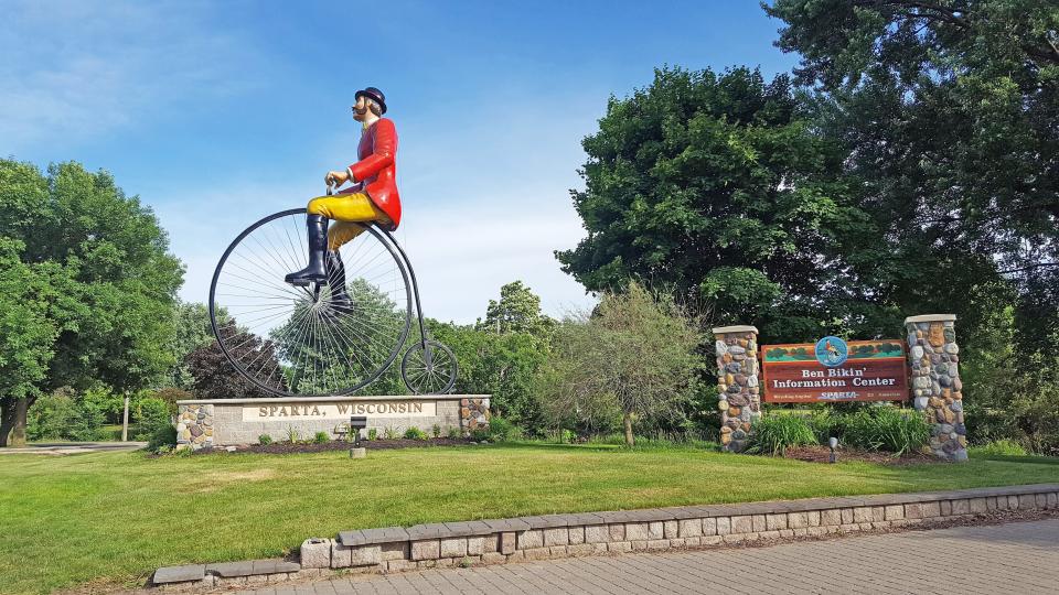 Ben Bikin, the World's Largest Bicyclist, sits on a 19th-century high wheel bicycle in Sparta near one end of the Elroy-Sparta State Trail.