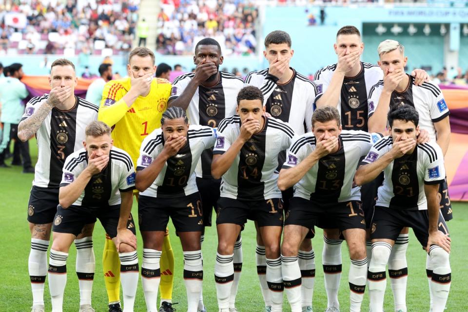 German players pose with thier hands covering their mouths at the World Cup in Qatar (Alexander Hassenstein/Getty Images)