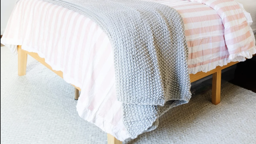 pre teen bedroom with pink and pattern accent wall