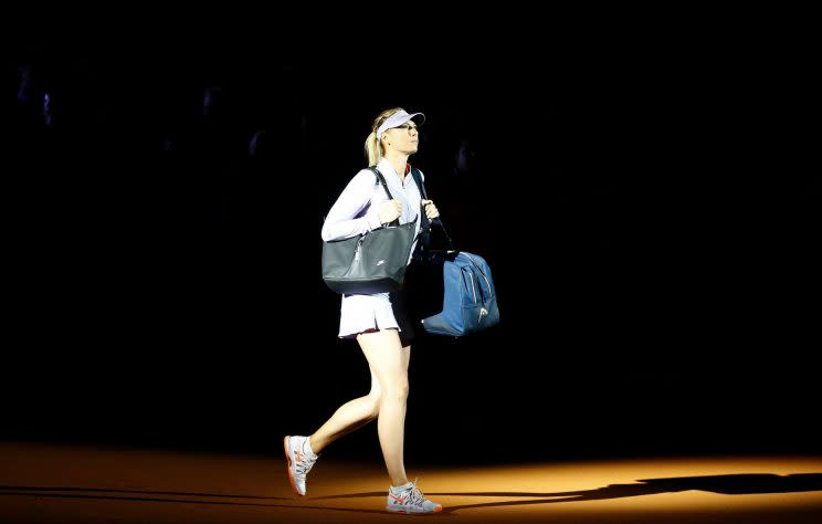 Maria Sharapova arrives on court for her first match since being suspended for 15 months. (REUTERS)