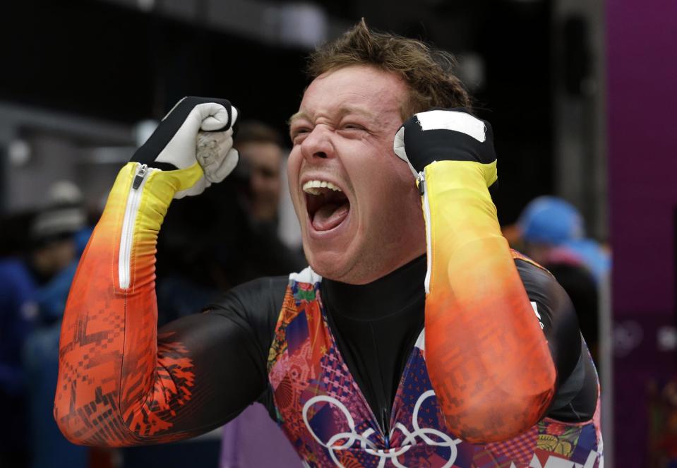 Felix Loch of Germany celebrates after he crossed the finish area to win the gold medal during the men's singles luge final at the 2014 Winter Olympics, Sunday, Feb. 9, 2014, in Krasnaya Polyana, Russia. (AP Photo/Natacha Pisarenko)