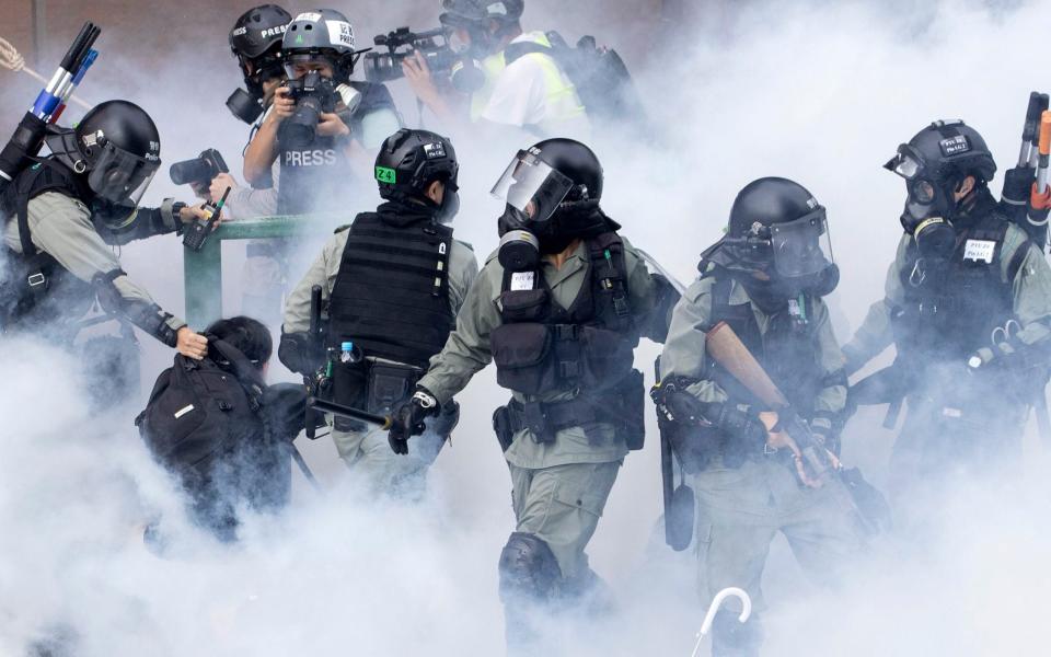 Police in riot gear dealing with protesters in 2019 - AP