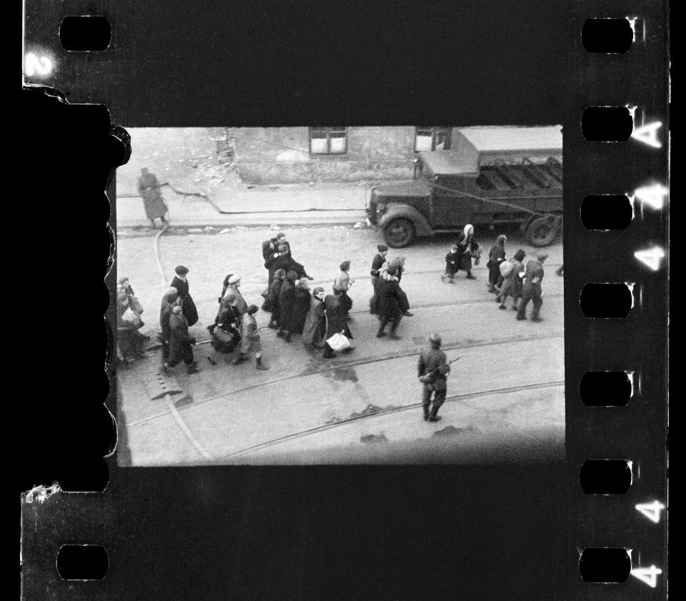 This handout negative dated on April 20, 1943, and taken by Polish firefighter Zbigniew Leszek Grzywaczewski negative shows jewish people being evacuated from the Ghetto to Umschlagplatz during the uprising of the Warsaw ghetto in 1943, Poland. On Wednesday, Jan. 18, 2023, Warsaw’s Jewish history museum presented a group of photographs taken in secret during the Warsaw Ghetto Uprising of 1943, some of which have never been seen before, that were recently discovered in a family collection. (Z. L. Grzywaczewski/courtesy of Maciej Grzywaczewski/POLIN Museum via AP)