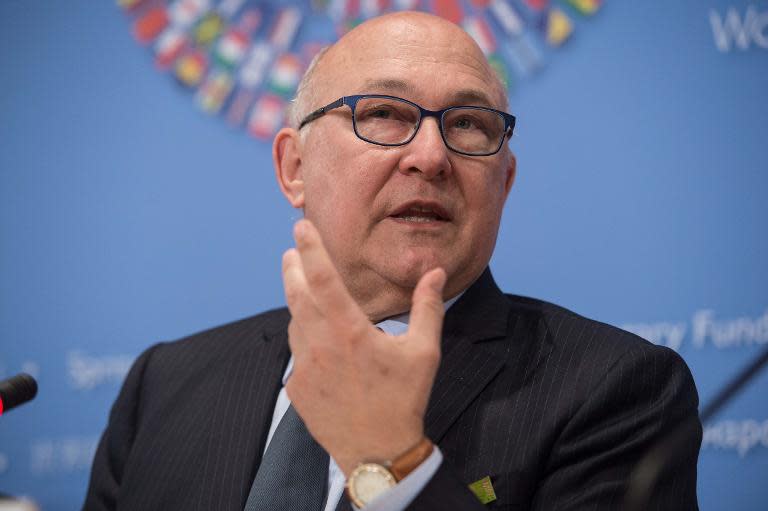 French Finance Minister Michel Sapin speaks at a press conference at the end of IMF/WB Spring Meetings in Washington, DC, on April 18, 2015