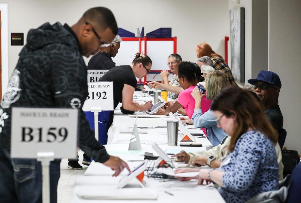 People check in to vote inside the Evangel World Prayer Center that was a voting hub for a few precincts. One election worker says voting has been busier since the primary. Nov.7, 2023.