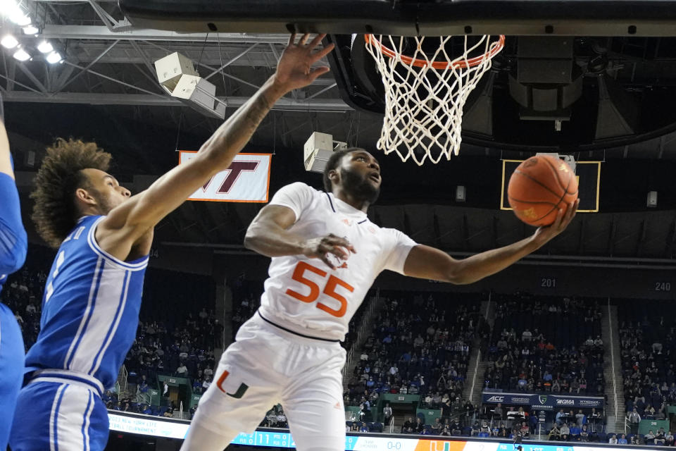 Miami guard Wooga Poplar (55) drives past Duke center Dereck Lively II (1) during the first half of an NCAA college basketball game at the Atlantic Coast Conference Tournament in Greensboro, N.C., Friday, March 10, 2023. (AP Photo/Chuck Burton)