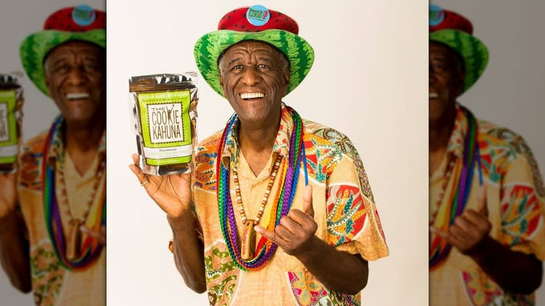 Wally Amos holding a Cookie Kahuna bag