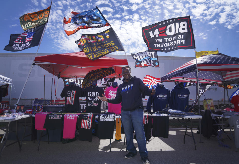 Thomas Isbell sells Donald Trump merchandise at a campaign rally for the former president, in Vandalia, Ohio, on Saturday, March 16, 2024. The former president has increasingly infused his campaign events with Christian rhetoric and imagery and continues to receive support from white evangelicals and other conservative Christians. (AP Photo/Jessie Wardarski)