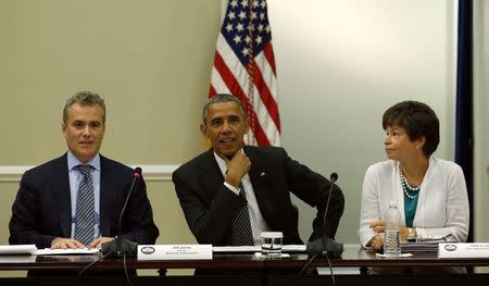 U.S. President Barack Obama holds a meeting with company executives and their small business suppliers to discuss ways to strengthen the economy at the White House in Washington July 11, 2014. Flanking Obama are National Economic Council Director Jeff Zients (L) and senior advisor Valerie Jarrett. REUTERS/Kevin Lamarque