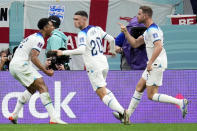 England's Jordan Henderson, right, celebrates with Jude Bellingham, left, after scoring the opening goal during the World Cup round of 16 soccer match between England and Senegal, at the Al Bayt Stadium in Al Khor, Qatar, Sunday, Dec. 4, 2022. (AP Photo/Manu Fernandez)