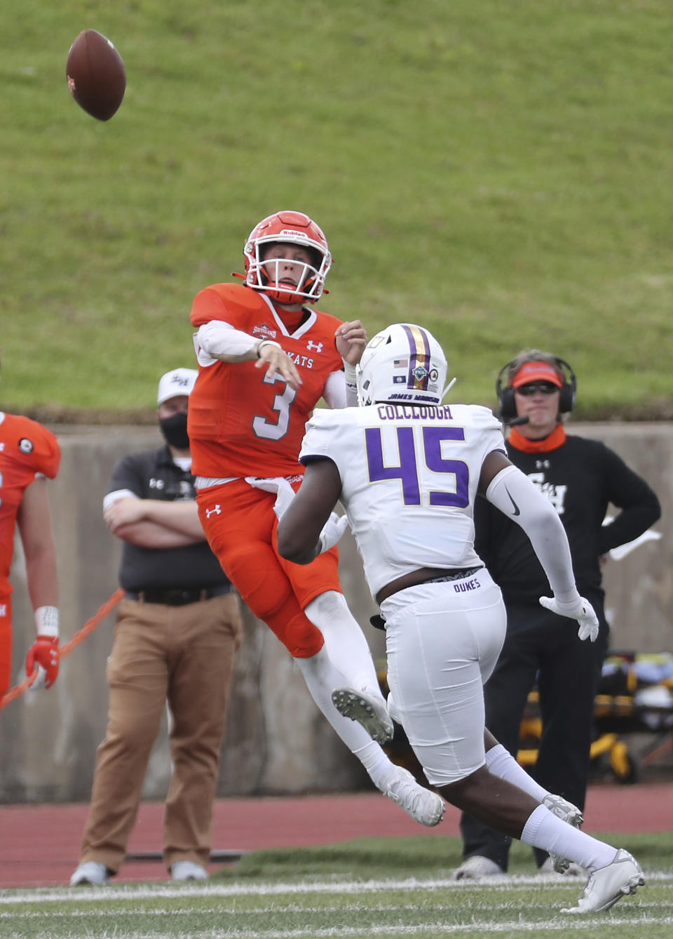 Sam Houston State quarterback Eric Schmid (3) gets off a pass over James Madison defensive lineman Antonio Colclough (45) during the third quarter of a semifinal game in the NCAA college football FCS playoffs, Saturday, May 8, 2021, in Huntsville, Texas. Sam Houston came from behind to edge James Madison 38-35, for a berth in the FCS national championship game. (Brett Coomer/Houston Chronicle via AP)