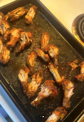 Cooked chicken wings arranged on a baking sheet