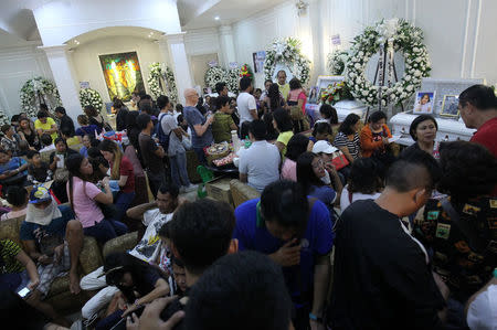 People gather during a wake of call centre workers killed during fire at a mall in Davao city, Philippines, December 28, 2017. REUTERS/Lean Daval Jr