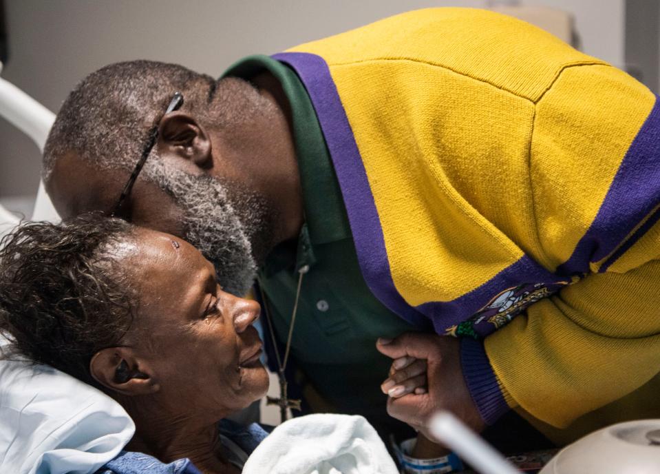 The Rev. Vincent Johnson kisses Mary Bradley on the cheek while she holds his hand as she recovers at the TriStar Skyline Medical Center in Nashville, Tenn., Tuesday, Dec. 12, 2023.