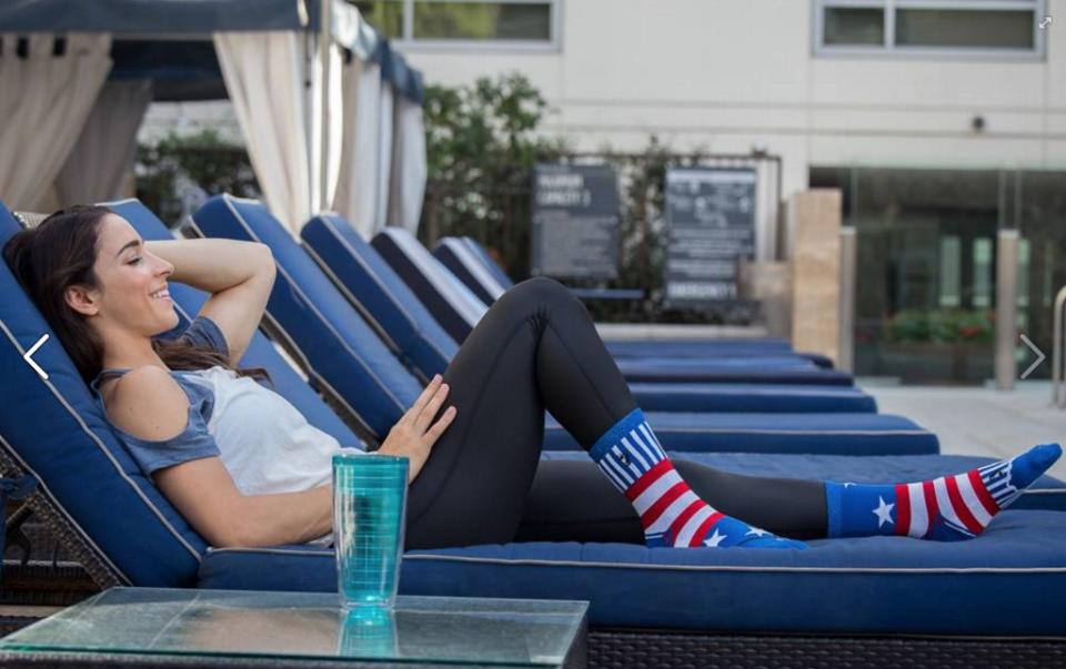 Raisman lounging poolside in one of her signature designs. (Photo: Courtesy of Facebook/featsocks)