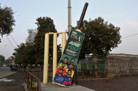 Huge wickets and a bat, with the pictures of cricket players display near the Gaddafi Stadium for the upcoming country's premier domestic Twenty20 tournament 'Pakistan Super League' in Lahore, Pakistan, Tuesday, Jan. 25, 2022. The Pakistan Cricket Board says "robust" COVID-19 health and safety protocols are in place ahead of its month-long domestic Twenty20 competition in Karachi and Lahore, with several foreign cricketers participating in a six-team event. (AP Photo/K.M. Chaudary)