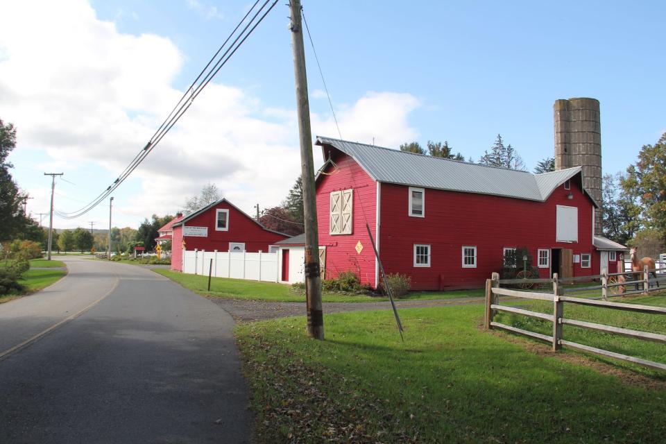 A red barn on a street.