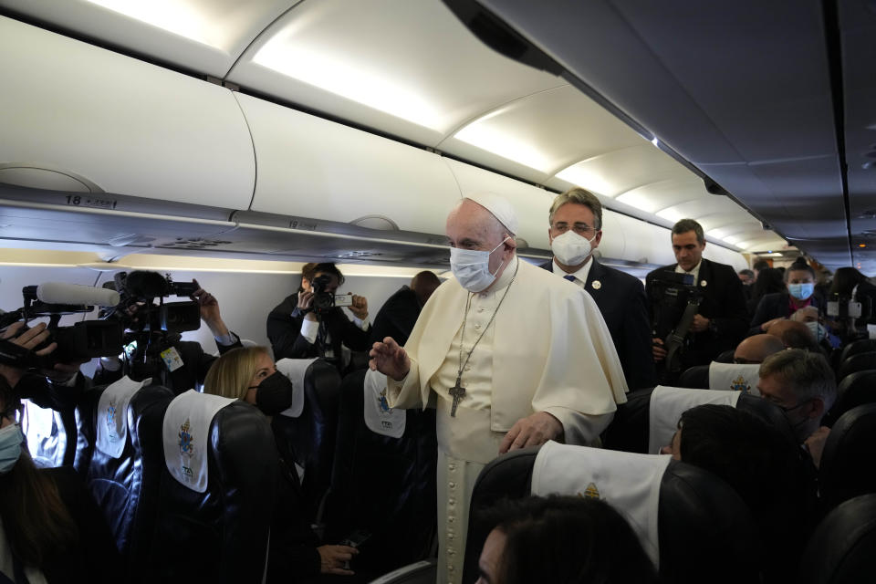 Pope Francis speaks during a news conference onboard the papal plane on the occasion of his five-day pastoral visit to Cyprus and Greece, Thursday, Dec. 2, 2021.(AP Photo/Alessandra Tarantino, Pool)