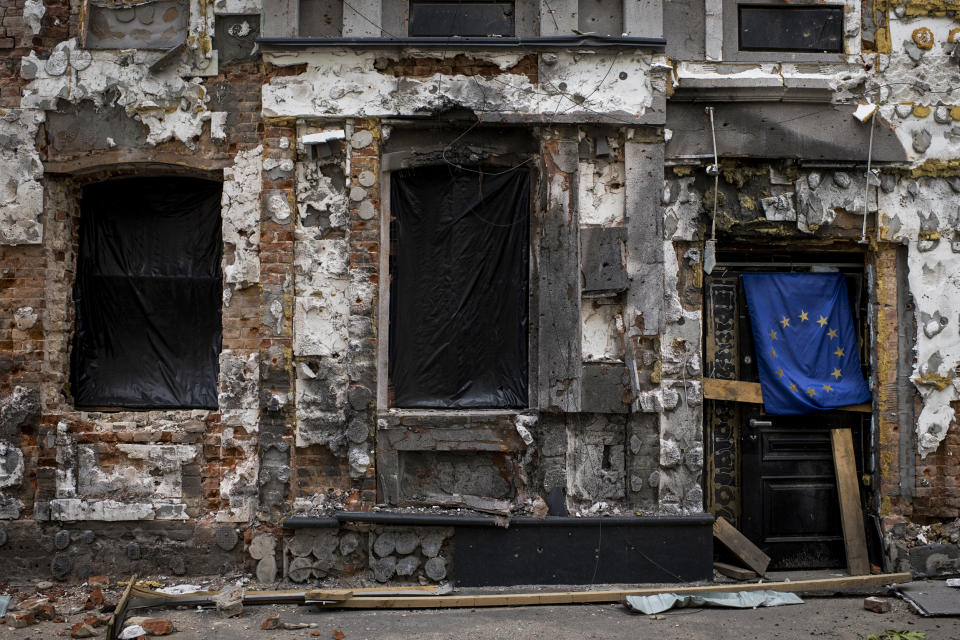 A heavily damaged facade of a building adjacent to the Faculty of Economics and Business School of the V.N. Karazin Kharkiv National University features the flag of the European Union on May 18, 2022, in Kharkiv, Ukraine. (Pete Kiehart for NBC News)