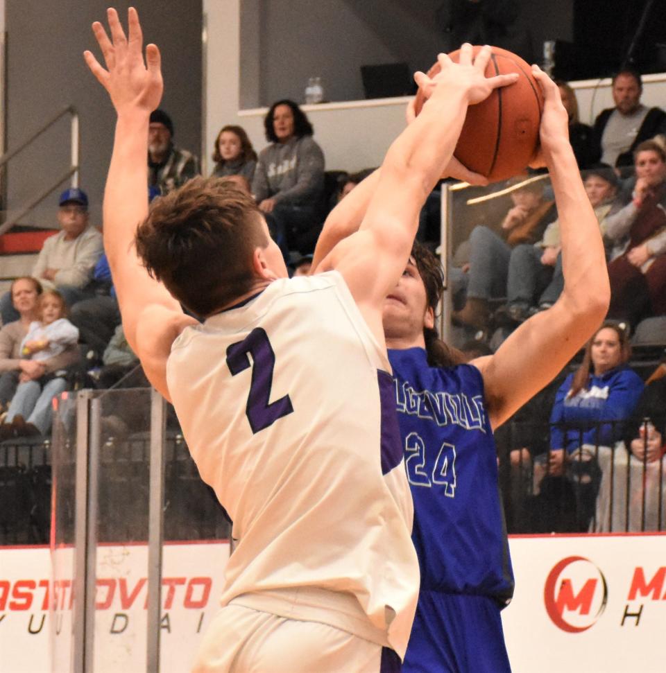 West Canada Valley Nighthawk Jayden Smith (2) gets his hand on a shot by Dolgeville Blue Devil Brett Mosher at the Nexus Center in Utica Saturday.