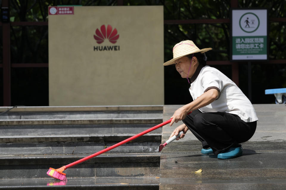 A worker washes the steps outside an entrance to the sprawling Huawei headquarters campus in Shenzhen, China, Saturday, Sept. 25, 2021. Two Canadians detained in China on spying charges were released from prison and flown out of the country on Friday, Prime Minister Justin Trudeau said, just after a top executive of Chinese communications giant Huawei Technologies reached a deal with the U.S. Justice Department over fraud charges and flew to China. (AP Photo/Ng Han Guan)