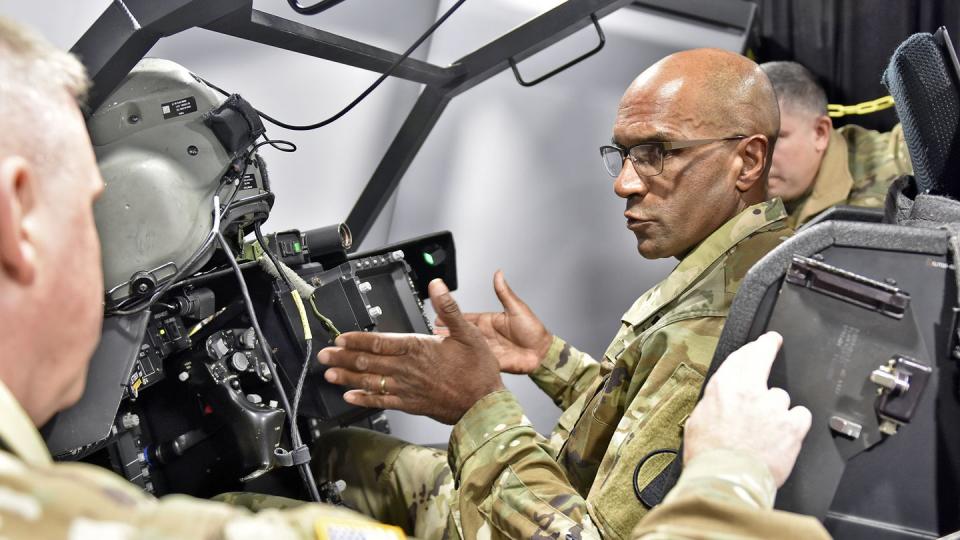 Gen. Gary Brito, commander of U.S. Army Training and Doctrine Command, discusses the AH-64 Apache Longbow Crew Trainer with Maj. Gen. Michael McCurry, U.S. Army Aviation Center of Excellence and Fort Rucker commander, at Fort Rucker, Alabama, November 16, 2022. (Lt. Col. Andy Thaggard/Army)
