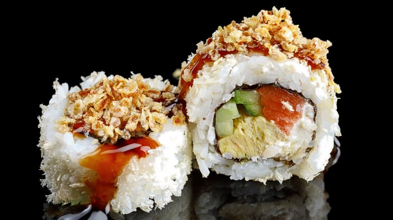 sushi rolls on black background