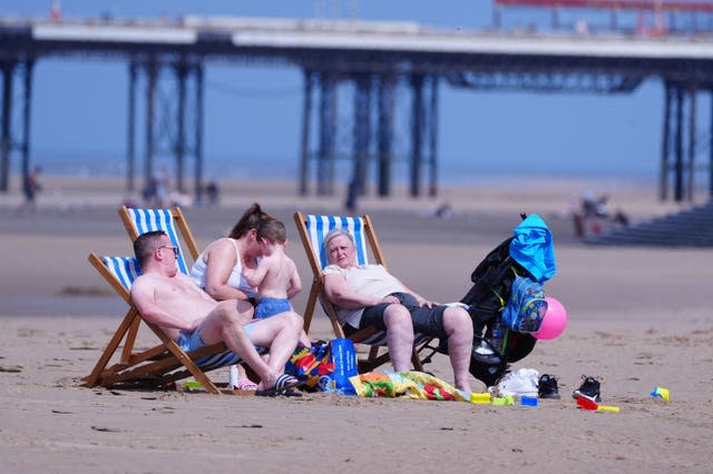 People sat in deckchairs on Blackpool beach in Lancashire