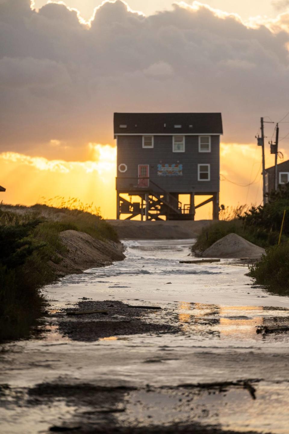 Ocean overwash settles in the street behind beach homes in Rodanthe Friday, Sept, 15, 2023 as Hurricane Lee churns in the Atlantic hundreds of miles offshore.