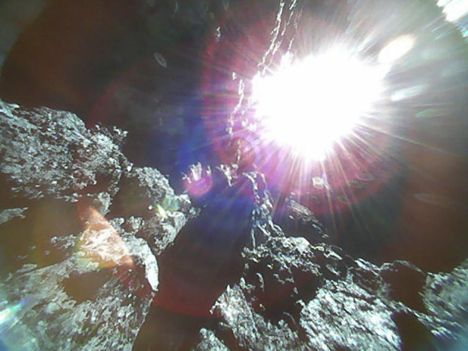 This Oct. 26, 2018, image captured by Rover-1A, and provided by the Japan Aerospace Exploration Agency (JAXA) on Thursday, Dec. 13, 2018, shows the surface of asteroid Ryugu. Japan's space agency JAXA said Thursday, Dec. 13, 2018, more than 200 photos taken by two small rovers on the asteroid show no signs of a smooth area for the planned touchdown of a spacecraft early next year. (JAXA via AP)