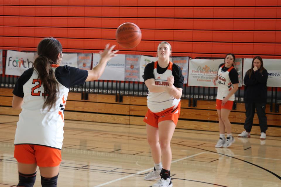 Artesia's Kymber Beltran (left) and Lorin Wagner pass during a practice session at the Bulldog Pit.